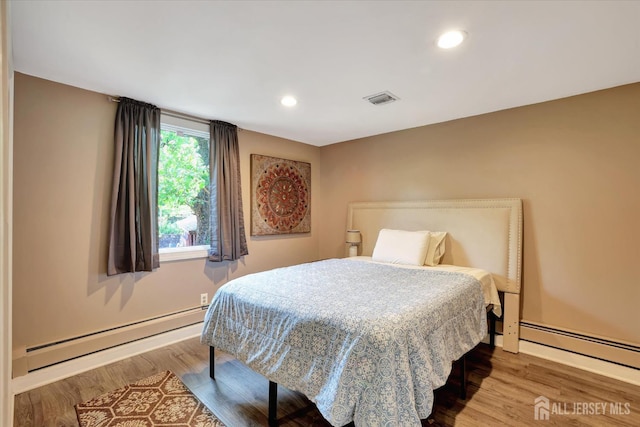 403 New Dover Rd, Colonia, NJ 07067 - bedroom with baseboard heating, wood finished floors, and recessed lighting