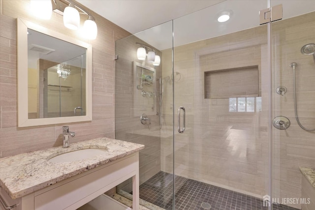 403 New Dover Rd, Colonia, NJ 07067 - bathroom featuring a stall shower, vanity, and tile walls