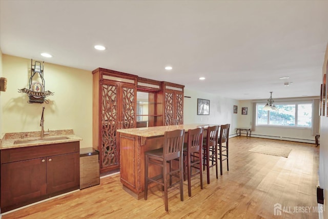 403 New Dover Rd, Colonia, NJ 07067 - indoor bar featuring light wood-style floors, recessed lighting, a baseboard radiator, and hanging light fixtures