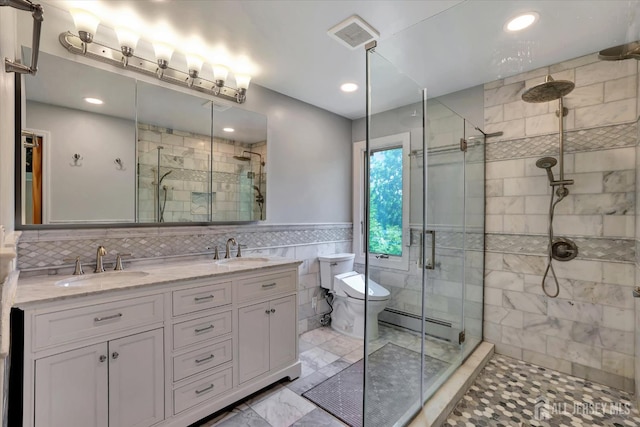 403 New Dover Rd, Colonia, NJ 07067 - full bathroom with tile walls, a shower stall, a baseboard heating unit, double vanity, and marble look tile flooring