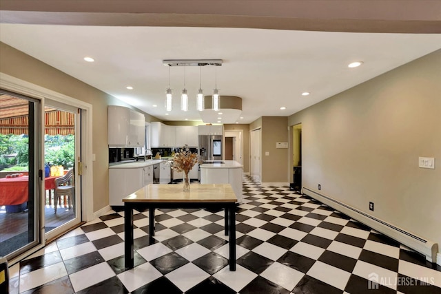 403 New Dover Rd, Colonia, NJ 07067 - kitchen featuring baseboard heating, light countertops, white cabinetry, a kitchen island, and decorative light fixtures