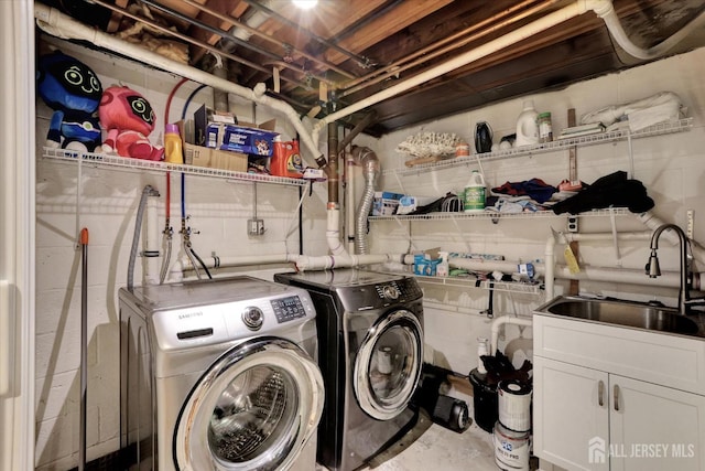 403 New Dover Rd, Colonia, NJ 07067 - laundry room featuring washing machine and dryer, concrete block wall, and cabinet space