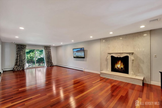 403 New Dover Rd, Colonia, NJ 07067 - unfurnished living room with wood finished floors, a fireplace, recessed lighting, and a baseboard heating unit