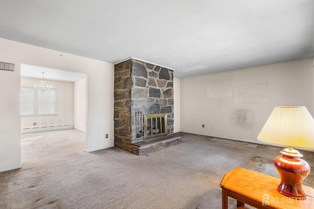 unfurnished living room with carpet floors, an inviting chandelier, a fireplace, and a baseboard heating unit