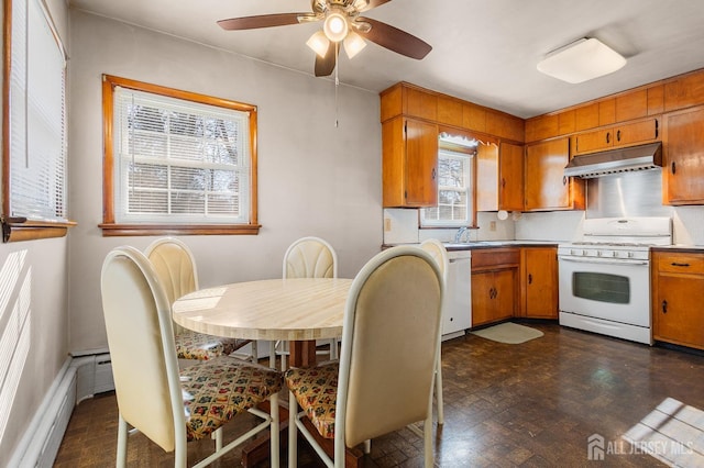 kitchen featuring white appliances, range hood, brown cabinets, and light countertops