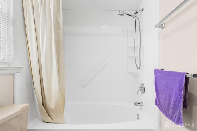 bathroom with shower / tub combo and toilet