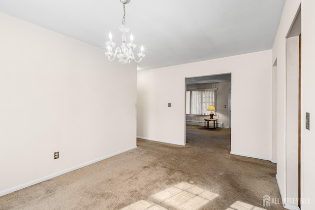 empty room featuring a baseboard radiator, a notable chandelier, baseboards, and carpet flooring