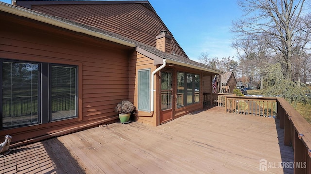 wooden deck with a sunroom