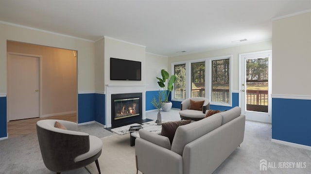 living area featuring a fireplace with flush hearth, light carpet, crown molding, and baseboards