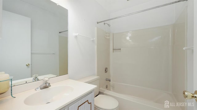 bathroom with bathtub / shower combination, vanity, and toilet