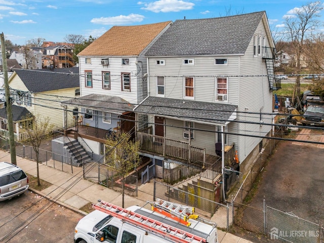 188 Seaman St, New Brunswick, NJ 08901 - rear view of house with stairway, roof with shingles, a residential view, and a fenced backyard