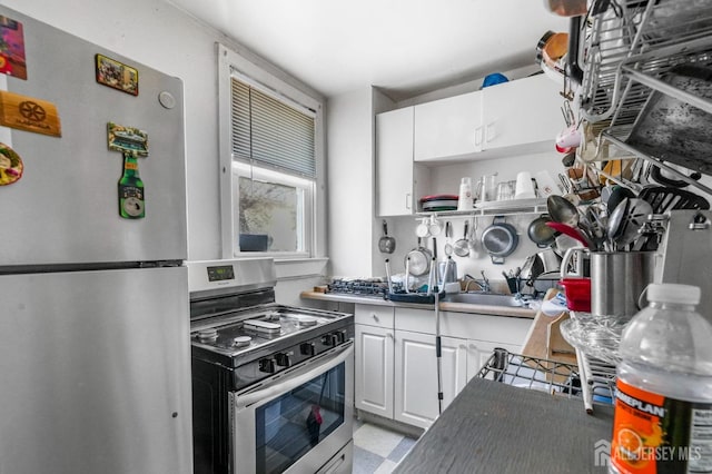188 Seaman St, New Brunswick, NJ 08901 - kitchen with stainless steel appliances, white cabinets, open shelves, and a sink