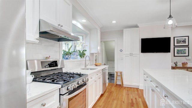 939 Salem Rd, Union Twp, NJ 07083 - kitchen with appliances with stainless steel finishes, under cabinet range hood, white cabinets, ornamental molding, and light wood-style floors