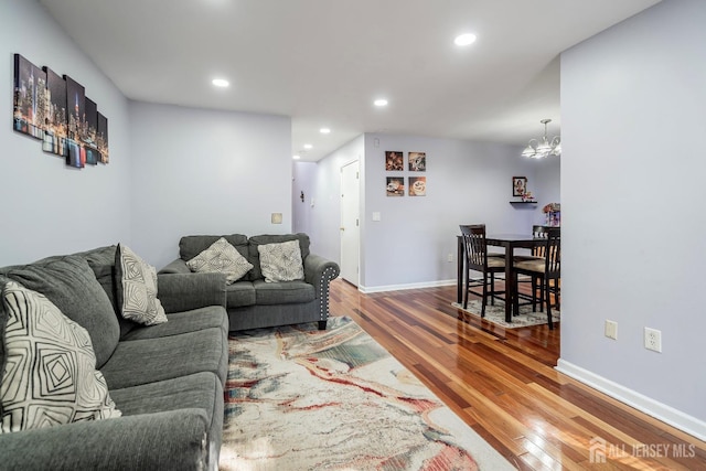 living room featuring an inviting chandelier and wood-type flooring