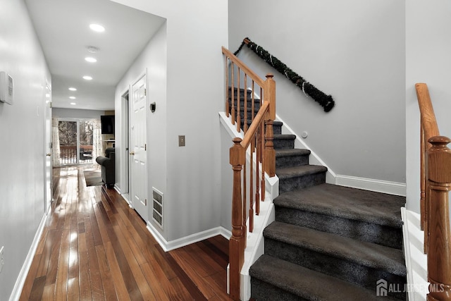 stairs with hardwood / wood-style flooring