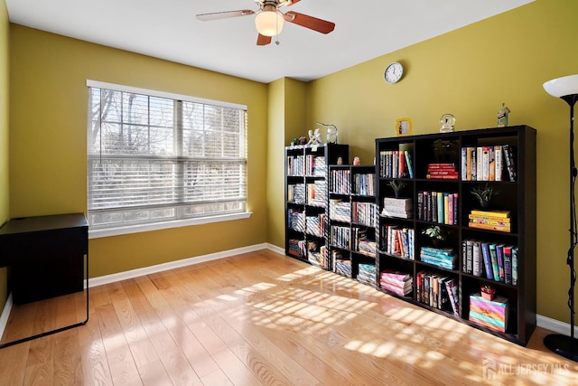 sitting room with ceiling fan and light wood-type flooring