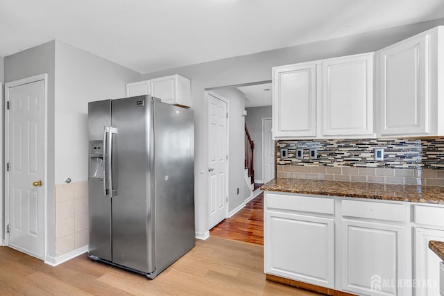 30 Montague Ave, Woodbridge Proper, NJ 08830 - kitchen featuring stainless steel fridge, light wood-type flooring, white cabinets, dark stone counters, and tasteful backsplash