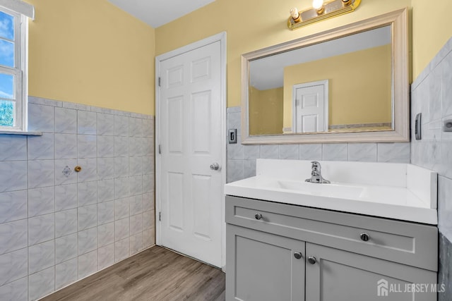 30 Montague Ave, Woodbridge Proper, NJ 08830 - bathroom featuring tile walls, vanity, wood finished floors, and wainscoting