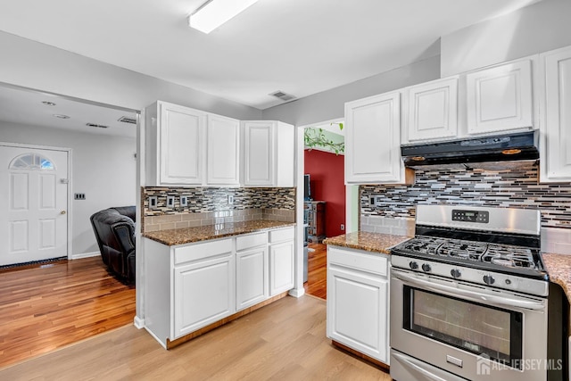 30 Montague Ave, Woodbridge Proper, NJ 08830 - kitchen with stainless steel range with gas stovetop, under cabinet range hood, light wood-type flooring, and white cabinetry