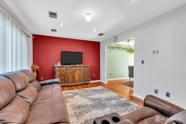 30 Montague Ave, Woodbridge Proper, NJ 08830 - living room with an accent wall, recessed lighting, and wood finished floors