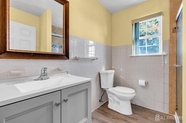 30 Montague Ave, Woodbridge Proper, NJ 08830 - full bathroom featuring tile walls, a stall shower, vanity, wood finished floors, and wainscoting