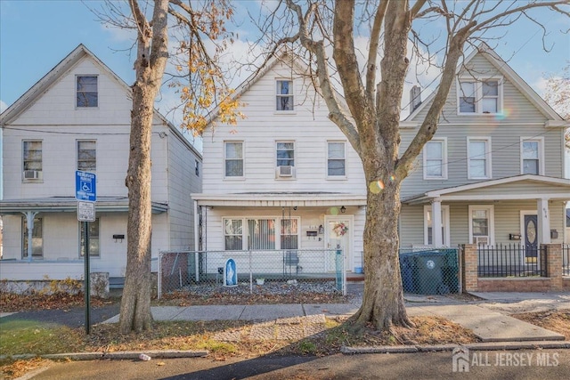 view of front of house with a fenced front yard and a porch