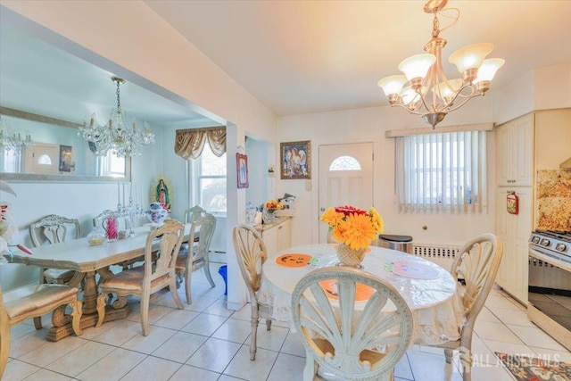 dining area with plenty of natural light, a notable chandelier, and light tile patterned flooring