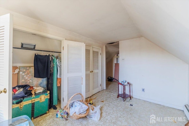 additional living space featuring a baseboard heating unit and vaulted ceiling