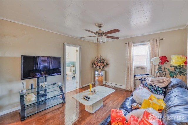 living room with ceiling fan, wood finished floors, baseboards, ornamental molding, and baseboard heating