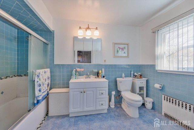 bathroom with enclosed tub / shower combo, toilet, tile walls, tile patterned floors, and radiator heating unit