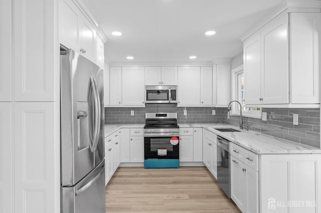 91 Dogwood Plz Unit A, Monroe, NJ 08831 - kitchen with appliances with stainless steel finishes, a sink, white cabinetry, backsplash, and recessed lighting