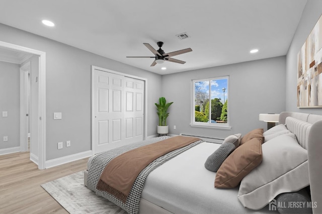 91 Dogwood Plz Unit A, Monroe, NJ 08831 - bedroom with a baseboard heating unit, light wood-style floors, baseboards, recessed lighting, and a closet