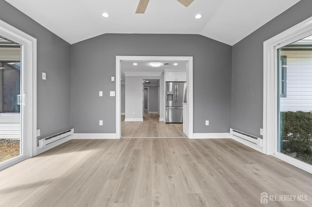 91 Dogwood Plz Unit A, Monroe, NJ 08831 - unfurnished living room with baseboard heating, light wood finished floors, vaulted ceiling, a ceiling fan, and baseboards