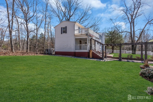 exterior space featuring stairs, a yard, and fence