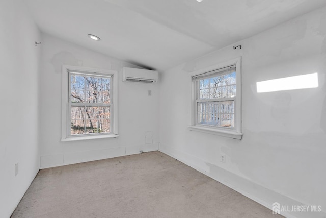 carpeted empty room featuring a wall mounted air conditioner, lofted ceiling, and recessed lighting