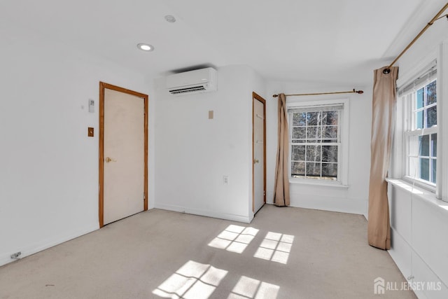 spare room featuring a wall unit AC and recessed lighting