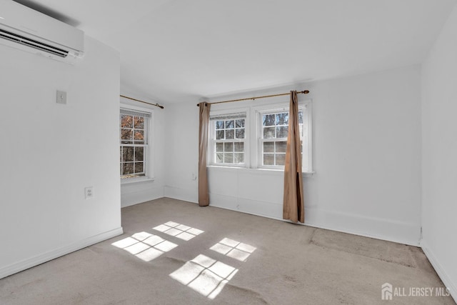 unfurnished room with baseboards and a wall mounted AC