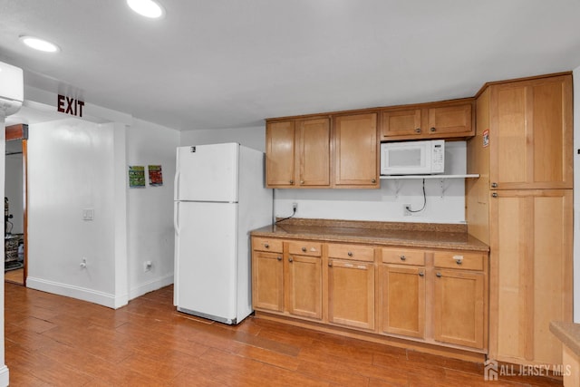 kitchen with white appliances, light wood-style flooring, recessed lighting, and baseboards