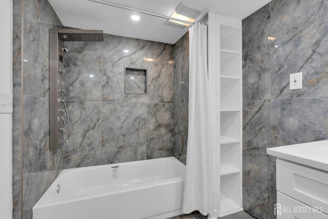 bathroom featuring tile walls and shower / tub combo with curtain