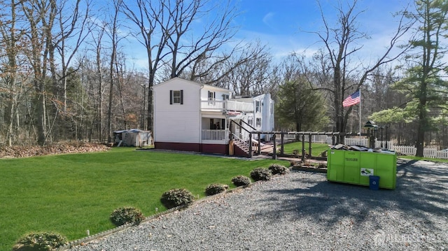 view of front of home featuring stairs, a front yard, and fence