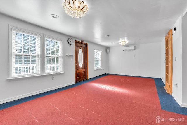 foyer featuring baseboards, carpet floors, and a wall mounted AC