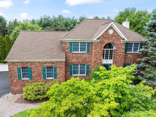 18 Stout Dr, Hillsborough, NJ 08844 - view of front of property featuring a chimney, roof with shingles, and brick siding