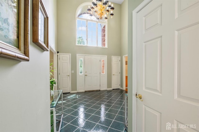 18 Stout Dr, Hillsborough, NJ 08844 - foyer entrance with a chandelier, a towering ceiling, and dark tile patterned floors