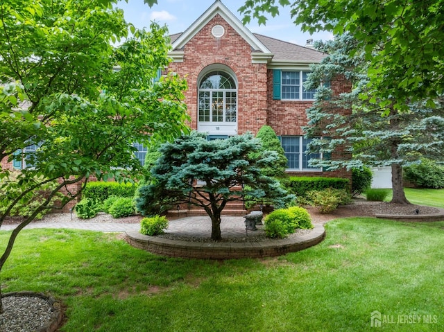 18 Stout Dr, Hillsborough, NJ 08844 - view of front of home with a front yard, brick siding, and roof with shingles