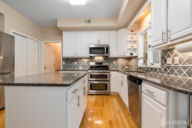 18 Stout Dr, Hillsborough, NJ 08844 - kitchen with appliances with stainless steel finishes, open shelves, a center island, light wood-style floors, and white cabinets