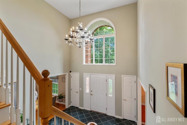 18 Stout Dr, Hillsborough, NJ 08844 - entrance foyer featuring a high ceiling, stairway, a chandelier, and dark tile patterned flooring