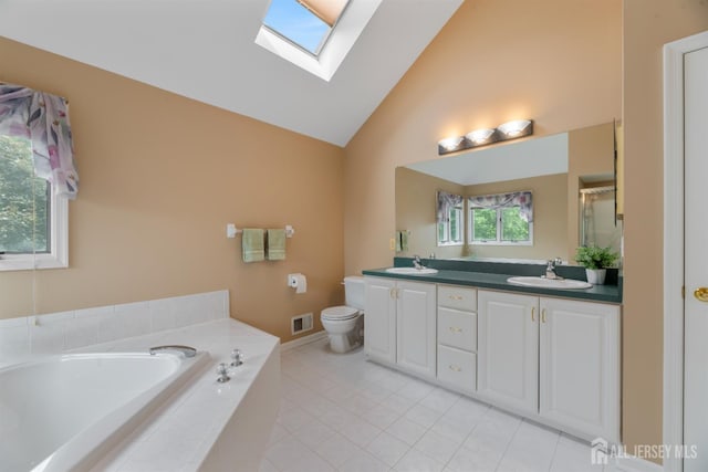 18 Stout Dr, Hillsborough, NJ 08844 - full bath featuring a skylight, double vanity, a bath, lofted ceiling, and tile patterned floors