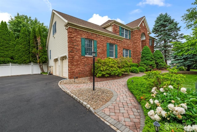 18 Stout Dr, Hillsborough, NJ 08844 - view of front facade featuring an attached garage, brick siding, and driveway