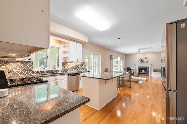 18 Stout Dr, Hillsborough, NJ 08844 - kitchen with stainless steel appliances, a center island, white cabinetry, open floor plan, and backsplash