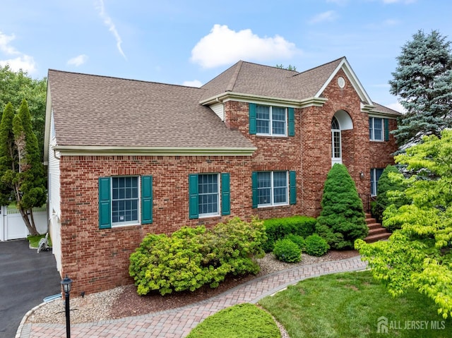 18 Stout Dr, Hillsborough, NJ 08844 - view of front of property featuring a shingled roof, brick siding, and driveway